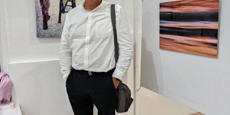 Dimitrios in fron of his artworks at Fire woman and sea exchibition